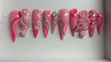 Load image into Gallery viewer, Set of pink nail art designs with decorative elements on a white background
